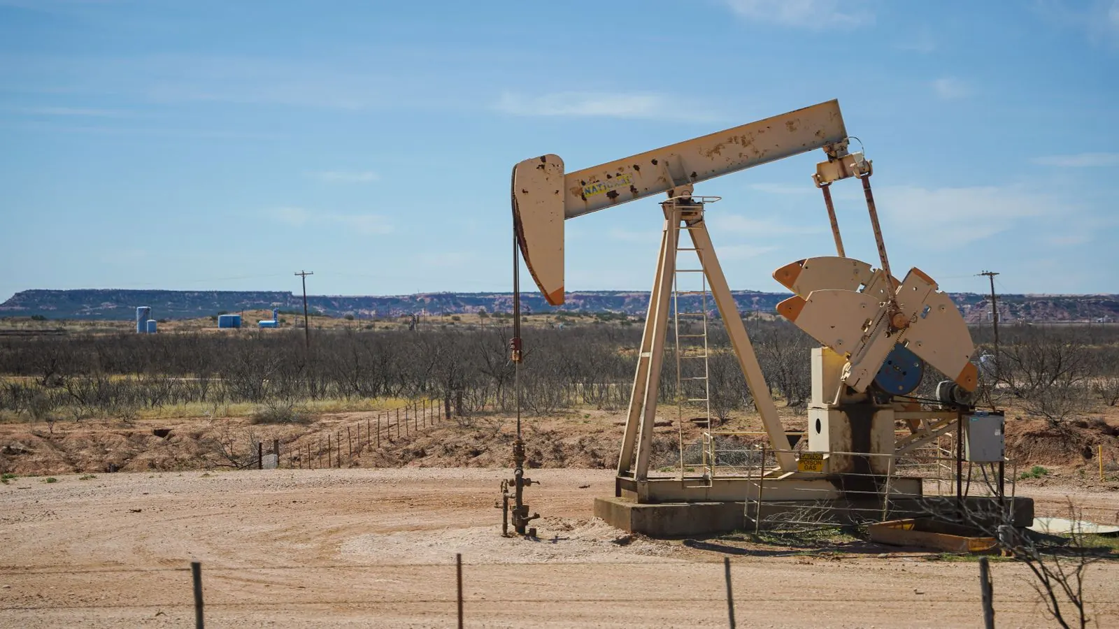 An oil pumpjack on a desert production site